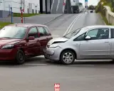 Wypadek samochodowy. Czerwone i srebrne auto po kolizji. Po takim zdarzeniu warto sprawdzić, jak sprawdzić ile mam zniżek na ubezpieczenie.