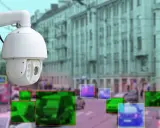 Kamera monitoringu miejskiego rejestruje ruch uliczny. Kolorowe ramki wskazują wykryte obiekty, potencjalnie do wystawienia mandatu z monitoringu miejskiego.