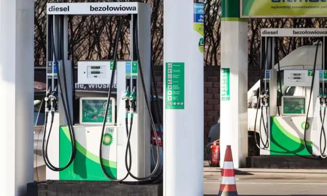 Stacja BP z dystrybutorami diesla i benzyny. Zimowe paliwo od kiedy dostępne? Na dystrybutorach widoczne logo BP i informacje o paliwach.